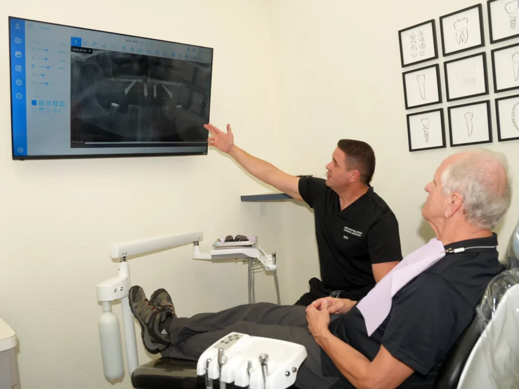 Dr. Miller showing X-ray to patient in dental chair